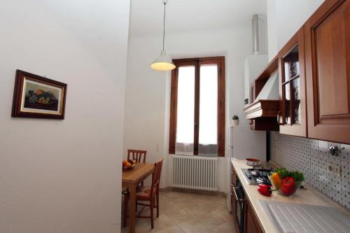 a kitchen with a table and a stove top oven at Dimora Pieri in Florence