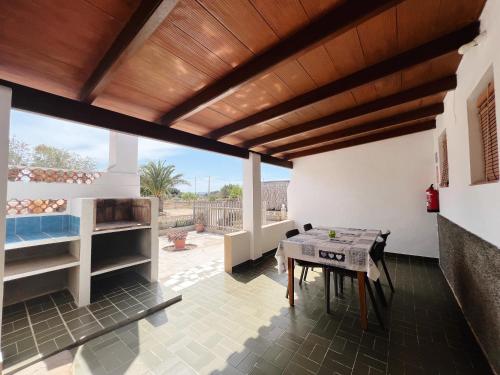 a living room with a table and a view at CASA VICENTE FUENTE in San Ferrán de ses Roques