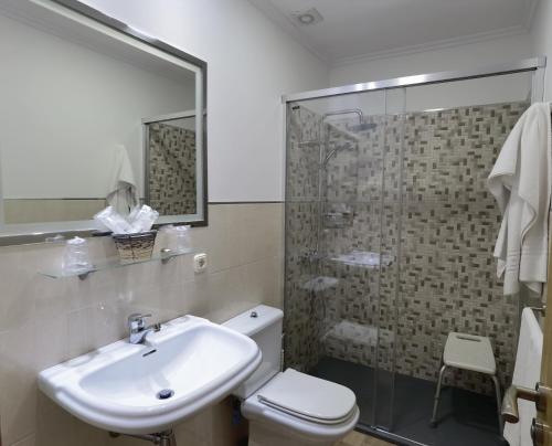 a bathroom with a sink and a toilet and a shower at Hotel Liñares in Poio