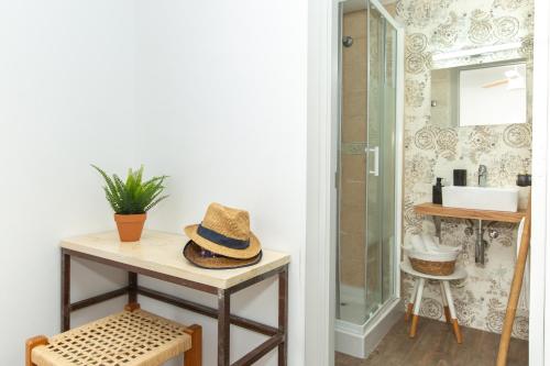 a hat sitting on a table in a bathroom at Balear Hotel in Ciutadella