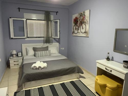 a bedroom with a bed with two stuffed animals on it at Karma - 2 bedroom apartment in Zakynthos Town