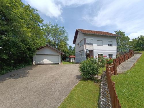 a house with a driveway next to a fence at Haus Viktoria near Banja Luka in Banja Luka