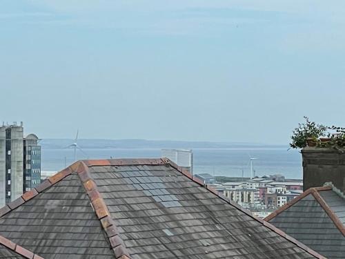 a roof of a building with the ocean in the background at The Mount in Swansea