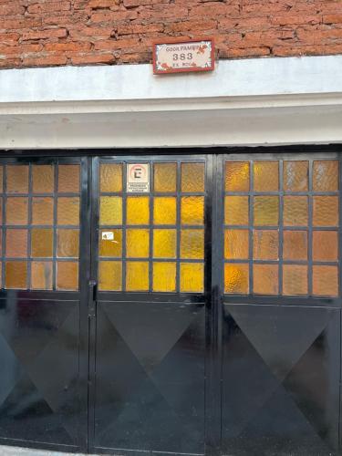 una porta d'ingresso di un edificio con vetri gialli di Monoambiente D en Ctes Cap a Corrientes