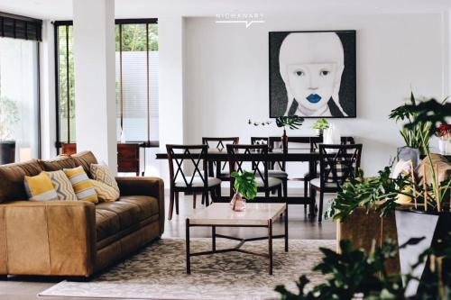 a living room with a couch and a table at The Sala Pattaya - SHA Certified in Jomtien Beach