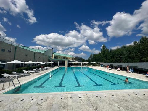 a large swimming pool with a person in the water at Hotel Arezzo ASC in Arezzo