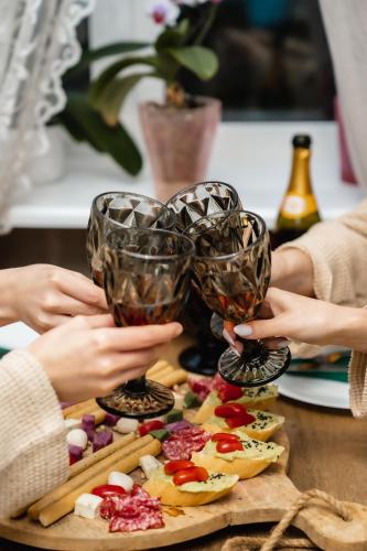 a group of people holding up wine glasses on a table at Hotel & Spa DENINNA in Vinnytsya