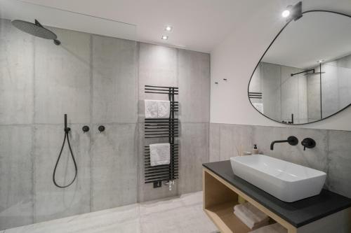 a bathroom with a sink and a shower with a mirror at Villa Rames in Ortisei