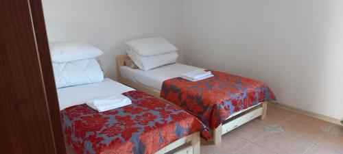 a small room with two twin beds and a bedskirts at Pokoje Vega in Bolszewo