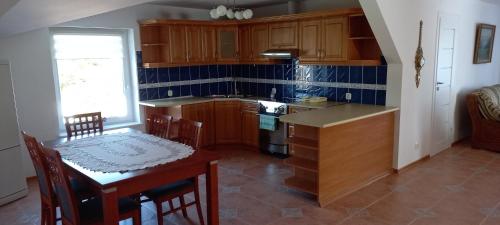 a kitchen with a table and a table and a dining room at Pokoje Vega in Bolszewo
