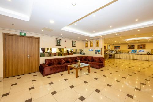 a lobby with a couch and a table in a building at Harmony Hotel Merter & SPA in Istanbul