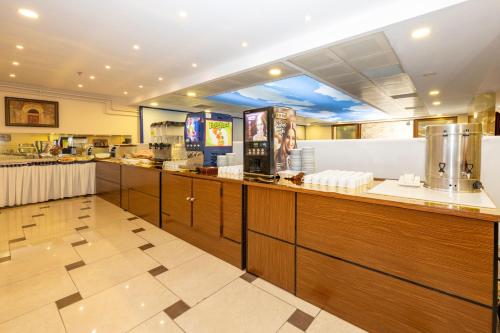 a fast food restaurant with a counter in a cafeteria at Harmony Hotel Merter & SPA in Istanbul