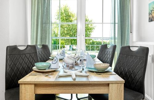 a dining room table with four chairs around it at Haus Sonnenschein Sonnenwinkel in Insel Poel