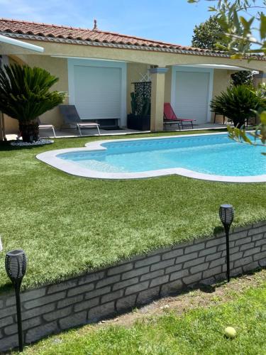 a swimming pool in the yard of a house at Chambre avec charme in Garons