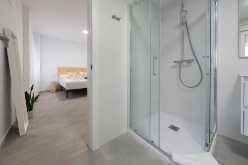 a bathroom with a shower with a glass door at Apartamento Marea Viva in Fisterra