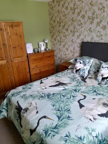 a bedroom with a bed with animals on it at Friendly Ventnor in Ventnor