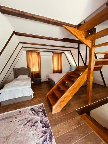 a room with two bunk beds and a staircase at Cozy Weekend House Zaid in Bihać