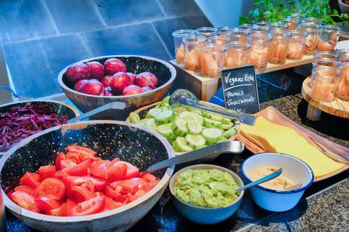a table topped with bowls of vegetables and dips at Welcome Hotel Bad Arolsen in Bad Arolsen