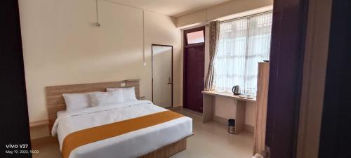a bedroom with a large bed and a window at MOCAHM in Shillong