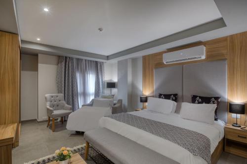 a hotel room with a large bed and a chair at Locanda Museum Hotel in Giza