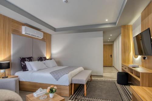 a hotel room with a bed and a flat screen tv at Locanda Museum Hotel in Giza