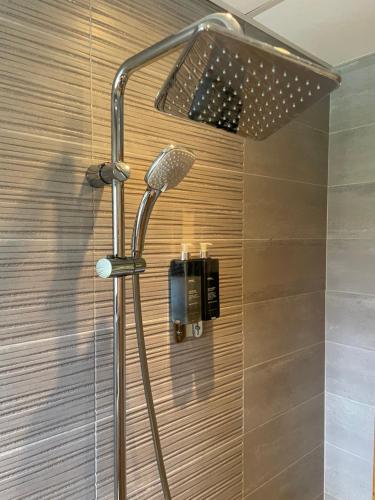 a shower with a shower head in a bathroom at Angliiska Vila in Arbanasi