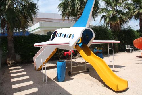 a toy airplane with a slide in the sand at Hacienda Guadalquivir in Córdoba