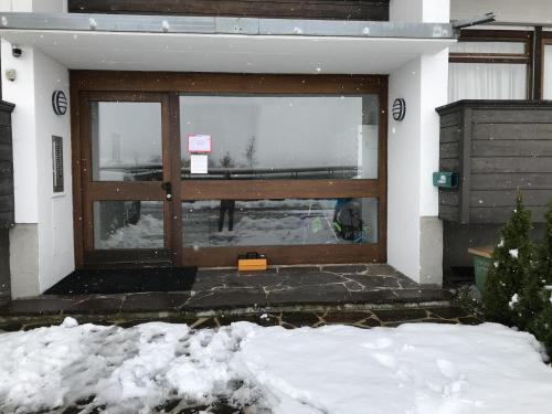 a front door of a house in the snow at Ellmauer Auszeit in Ellmau