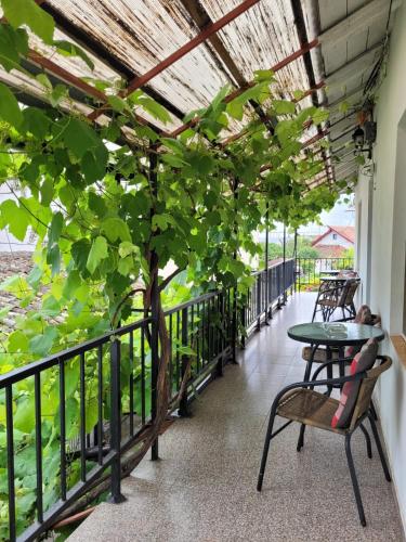 a balcony with a table and chairs and a tree at Vila Didi, Mangalia in Mangalia