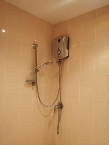 a shower in a bathroom with a shower head at Pool Villa 92 in Ban Nong Pru
