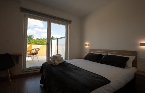 a bedroom with a bed with a stuffed animal on it at Pensión Roma in Castroverde