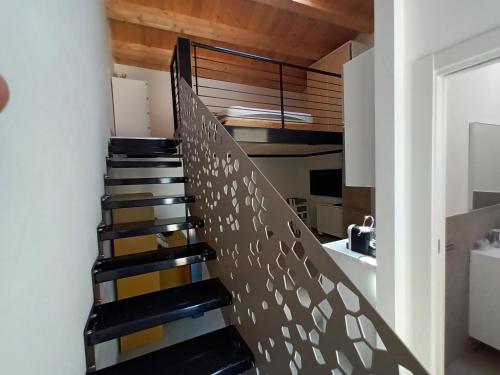 a staircase in a house with black and yellow stairs at Ke Rooms in Campomarino