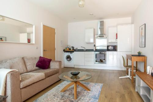 a living room with a couch and a table at 1 Bed Apartment - Redhill Central, Surrey, Gatwick #3 in Redhill