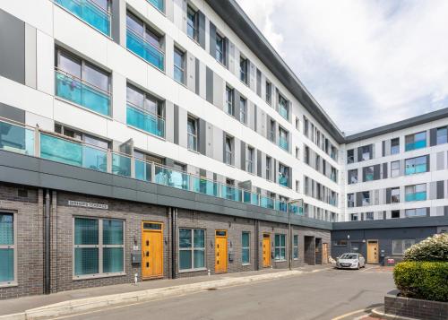 an external view of a building with yellow doors at 1 Bed Apartment - Redhill Central, Surrey, Gatwick #3 in Redhill