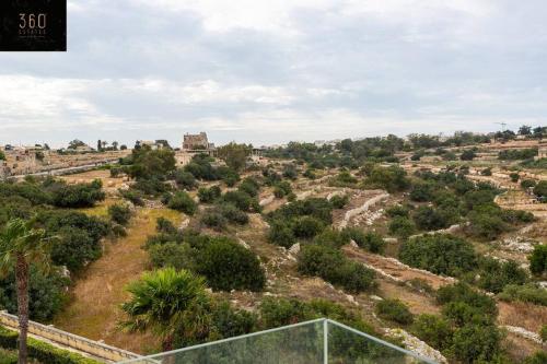 a view of a field with trees and bushes at Designer 3BR home, w/ lovely green views & WIFI by 360 Estates in Marsaxlokk