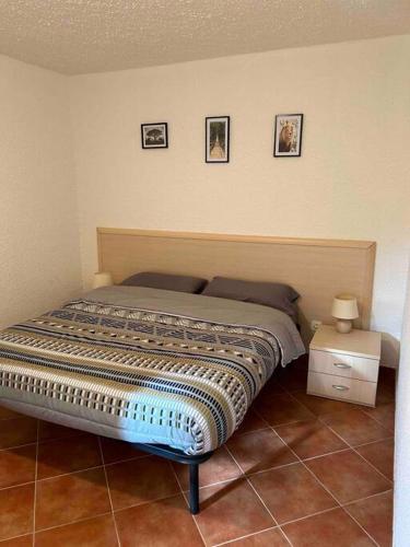 un lit dans une chambre avec des tableaux sur le mur dans l'établissement Appartement, 60m2, 6 couchages avec piscines à Marine de Bravone, Linguizetta, résidence Sognu Di mare Corse, à Linguizzetta