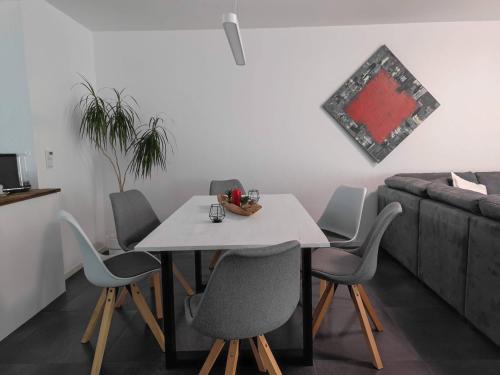 a table and chairs in a living room with a couch at Moers City Apartments in Moers