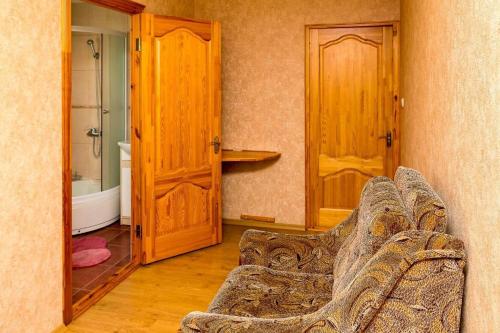 - un salon avec un canapé et des portes en bois dans l'établissement Anniņas, à Ventspils