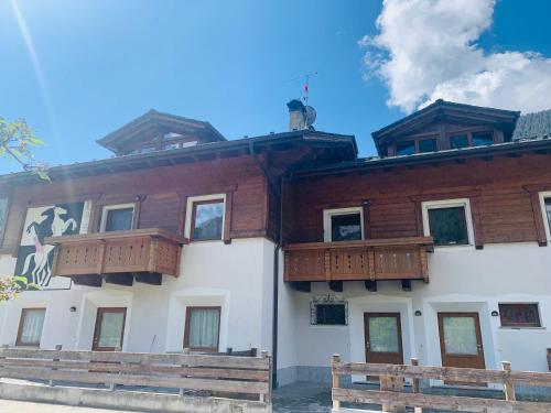 a building with wooden balconies on the side of it at Comodo rifugio montano LA STAFFA in Valdidentro in Premadio