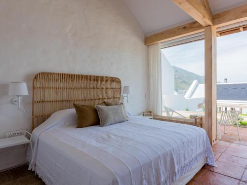 a bedroom with a large bed and a large window at Umoya Boutique Hotel & Villas in Cape Town