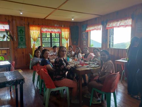 a group of people sitting at a table in a restaurant at Las vegas lodge and restaurant in Banaue