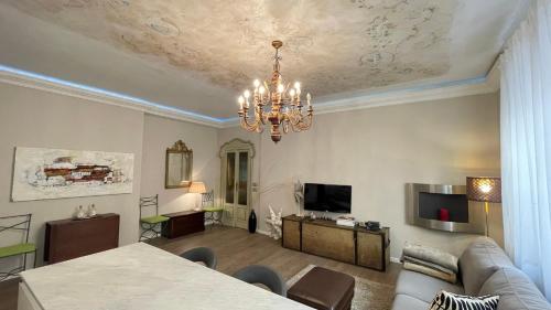 sala de estar con sofá y lámpara de araña en Boadream - Lussuoso appartamento in centro storico, en Parma