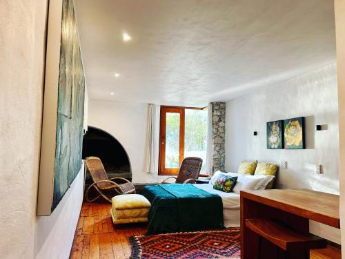 a bedroom with a bed and a table and chairs at Stay at Bokkoms in Paternoster Self Catering Accommodation in Paternoster