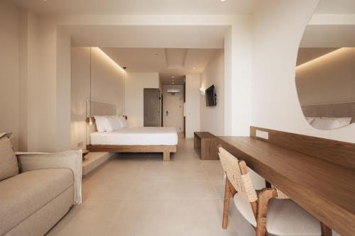 a hotel room with a bed and a couch at Ikyma Boutique in Polykhrono