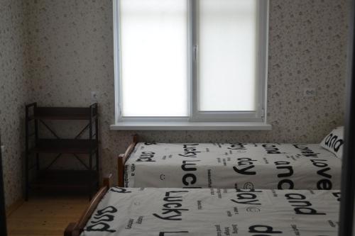 a bedroom with two beds and a window at Family & Relax Loft Lake House in Zagalʼtsy