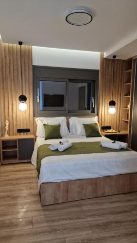 a bedroom with a large bed with two towels on it at Magdalena Suite 4.0 in Heraklio Town