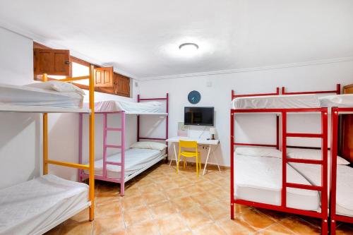 トレビエハにあるCasa Torrevieja La Mataの二段ベッド3台とデスクが備わる客室です。