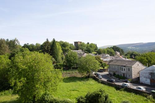 an aerial view of a small town with cars on a road at Pensión Roma in Castroverde