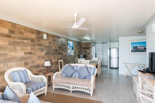 a living room with chairs and a brick wall at Le Paradis 5 - With Inverter in Ballito