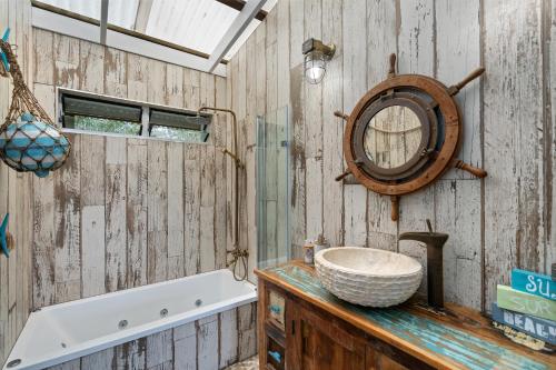 a bathroom with a sink and a mirror at Kahala in Point Lookout